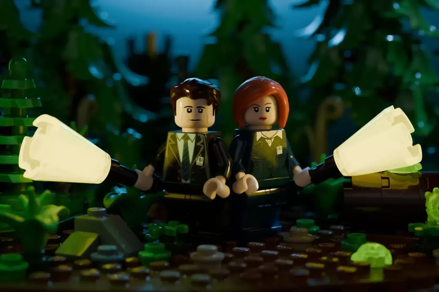 Two FBI minifigures hold flashlights in a forest setting with green foliage and blue atmospheric lighting.