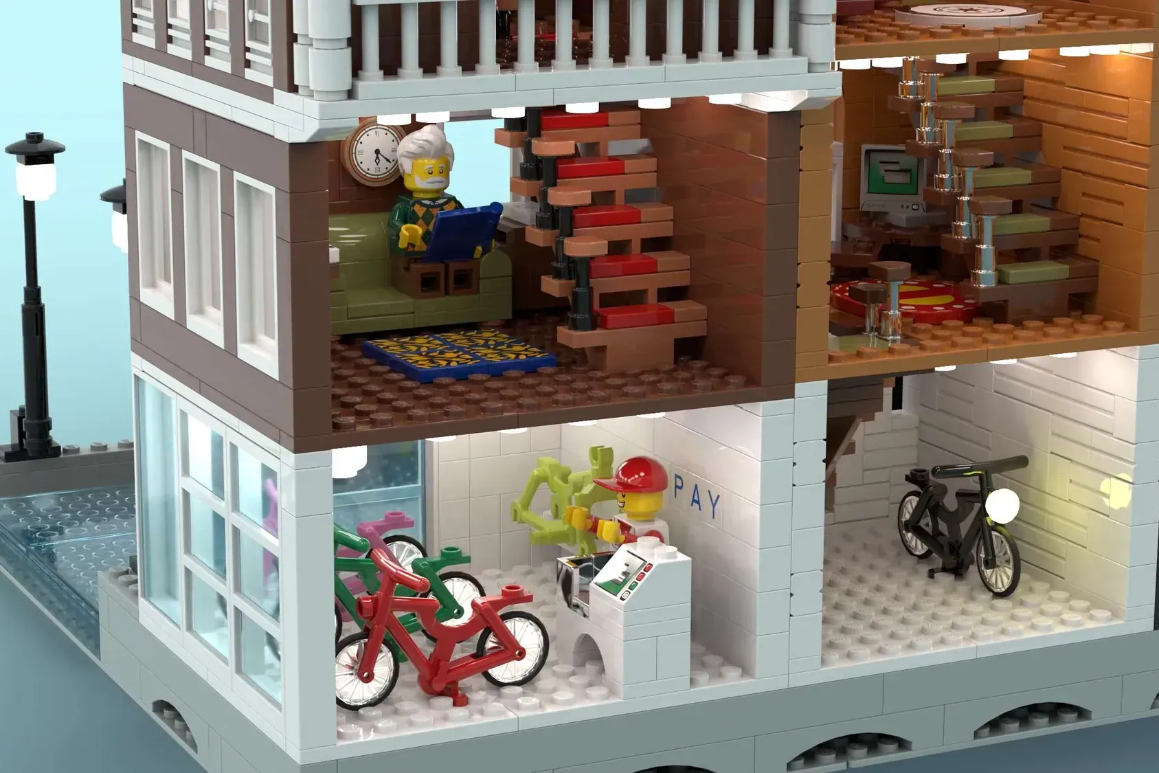 LEGO Amsterdam canal house set with bike shop, stairs, clock, and minifigures across multiple floors.