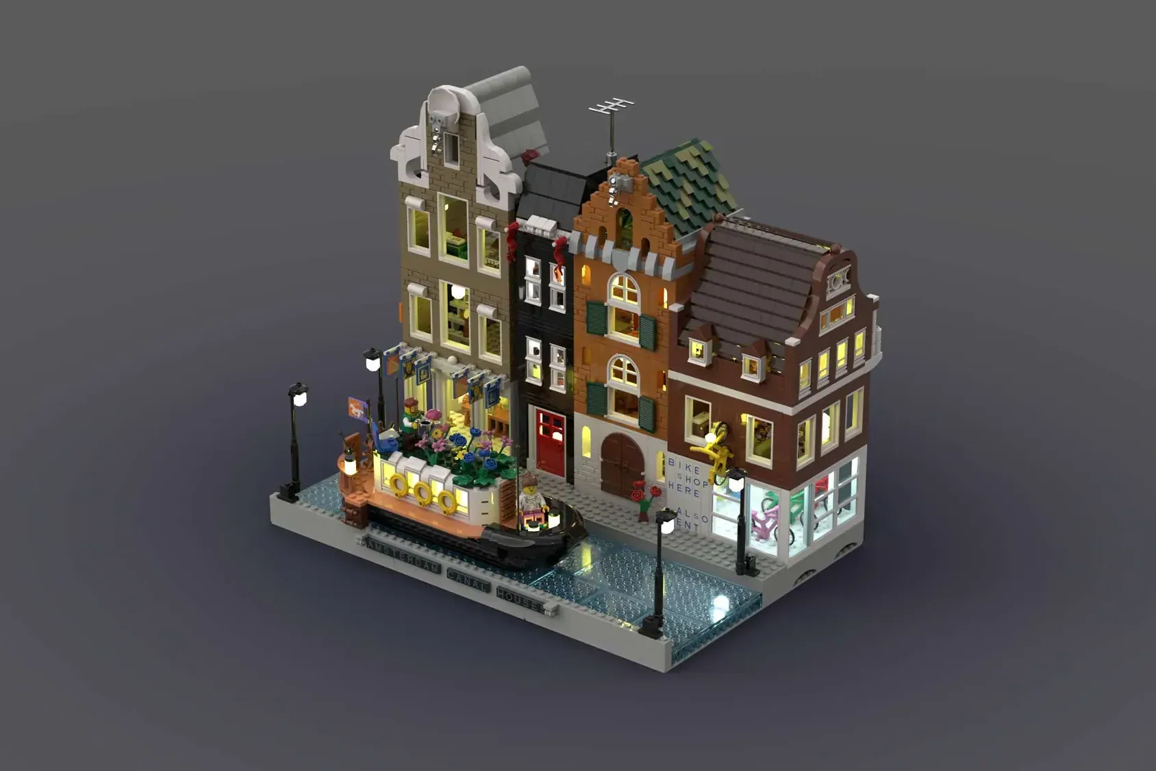 LEGO Amsterdam Canal Houses modular set with detailed storefronts, lit windows, and street-level bike shop display.