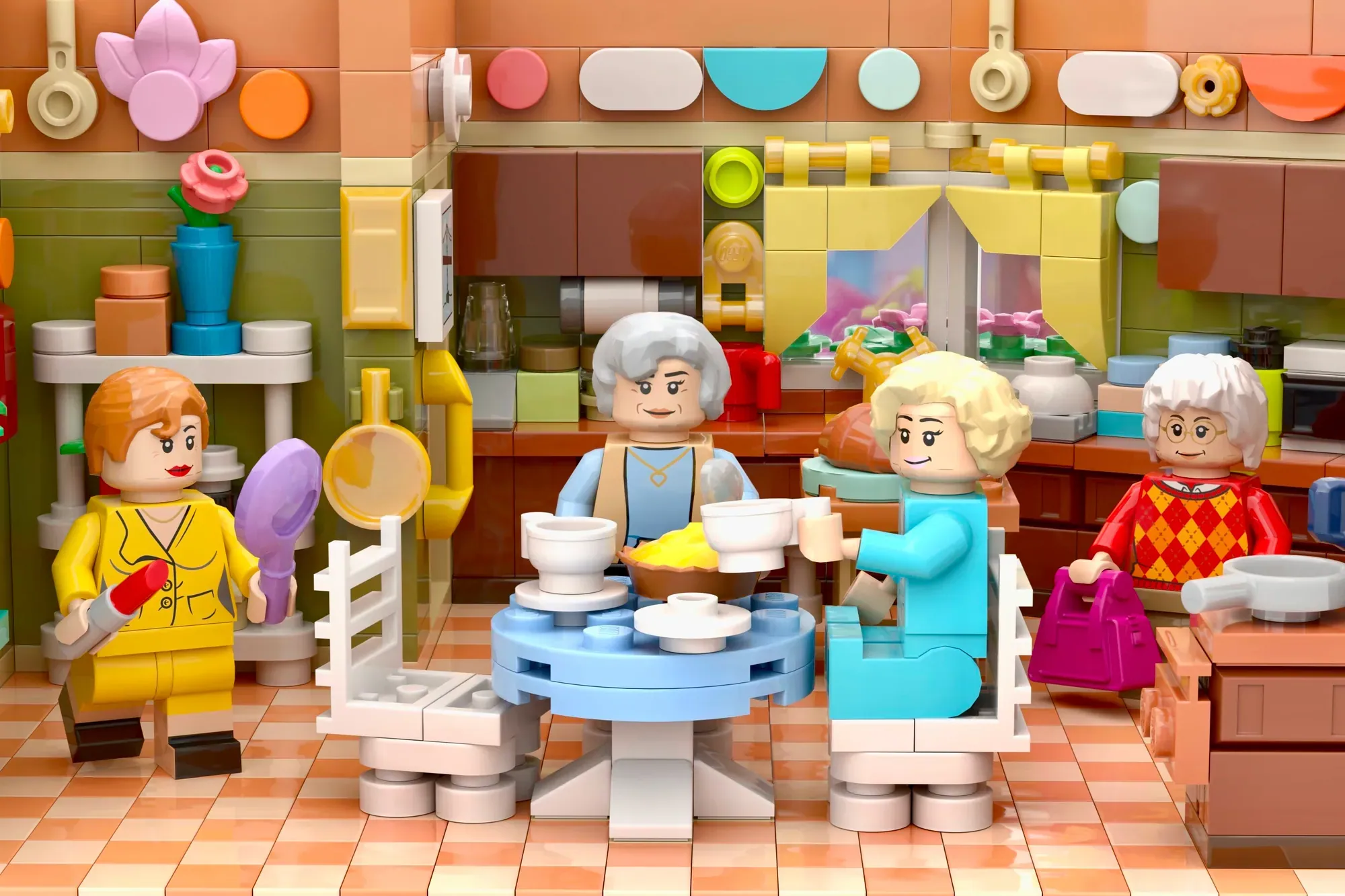 LEGO minifigures of four women with white/blonde hair gathered around a blue table in a colorful kitchen setting.