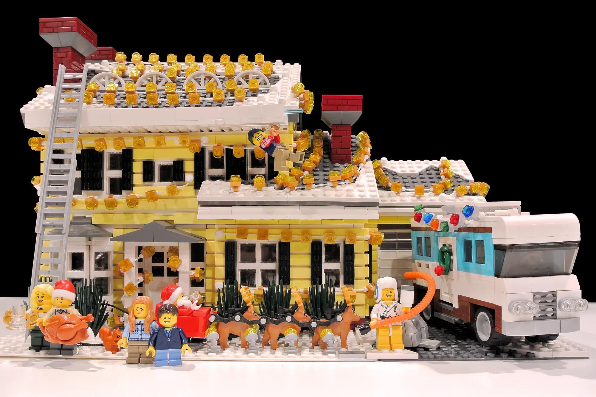 LEGO Griswold House decorated with hundreds of golden lights, minifigures, and a station wagon.