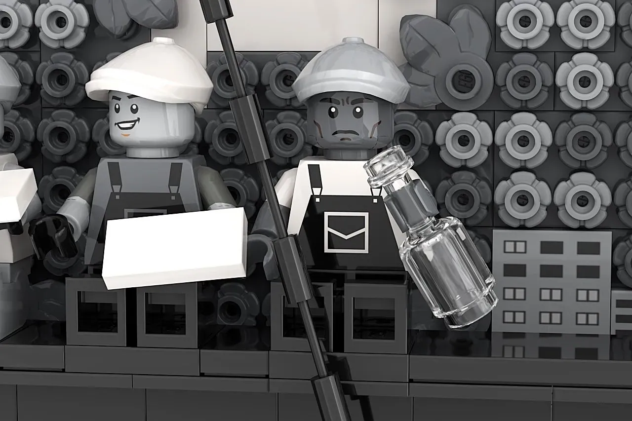 LEGO minifigures recreating "Lunch Atop a Skyscraper" on a building facade with construction elements.