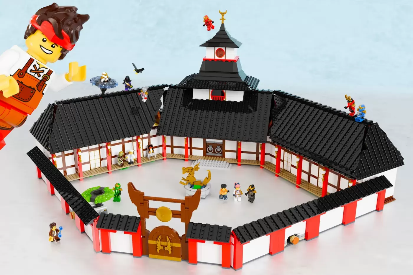 LEGO Ninjago Monastery with black tile roofs, red pillars, pagoda tower, minifigures, and dragon statue in courtyard.