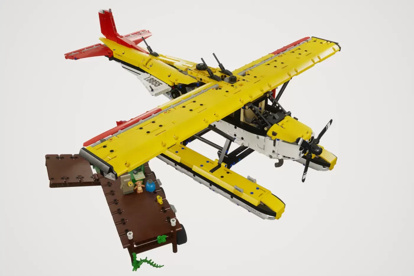 LEGO Cessna 185 float plane in yellow and red with minifigures, cargo, and teddy bear.
