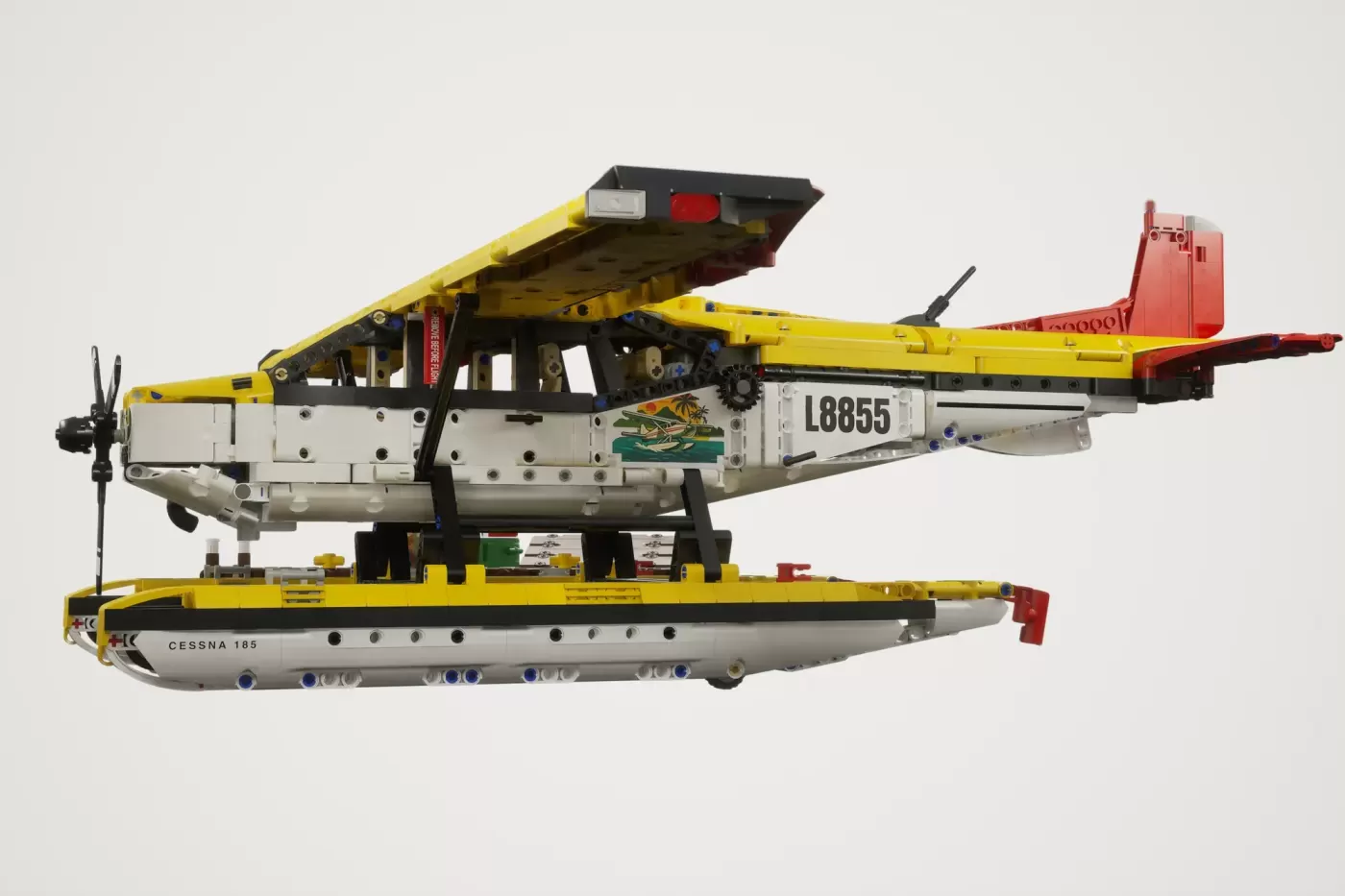 LEGO Cessna 185 float plane model with yellow and white fuselage, red floats, and propeller.
