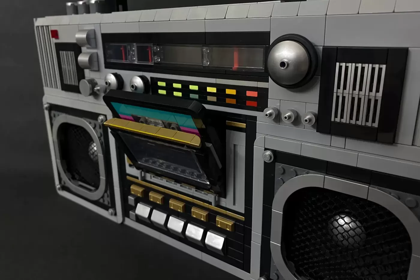 LEGO boombox with dual cassette decks, colorful equalizer display, speaker grills, and metallic accents in retro 1980s style.